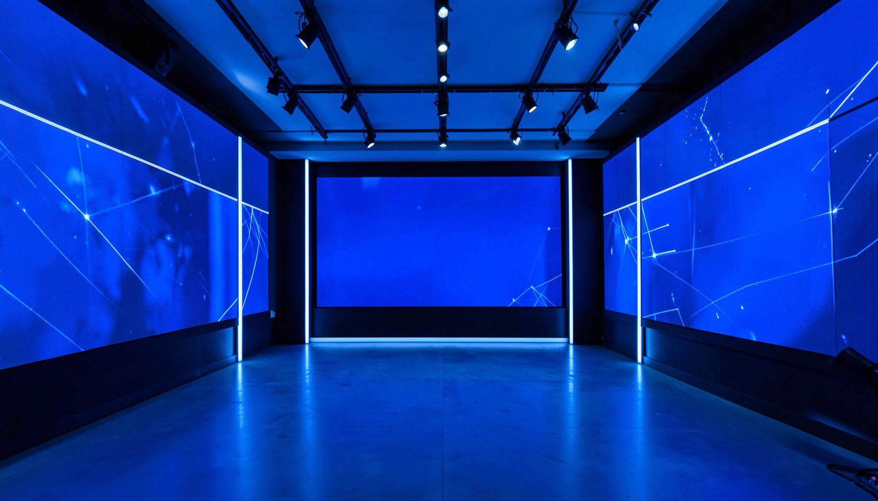 Modern digital news studio with large LED screens and cool blue-white lighting