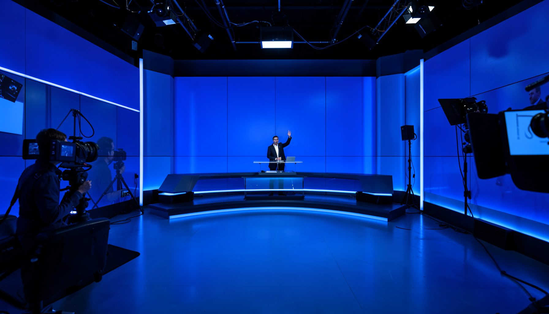 News broadcast desk with multiple camera angles and blue-tinted studio lighting